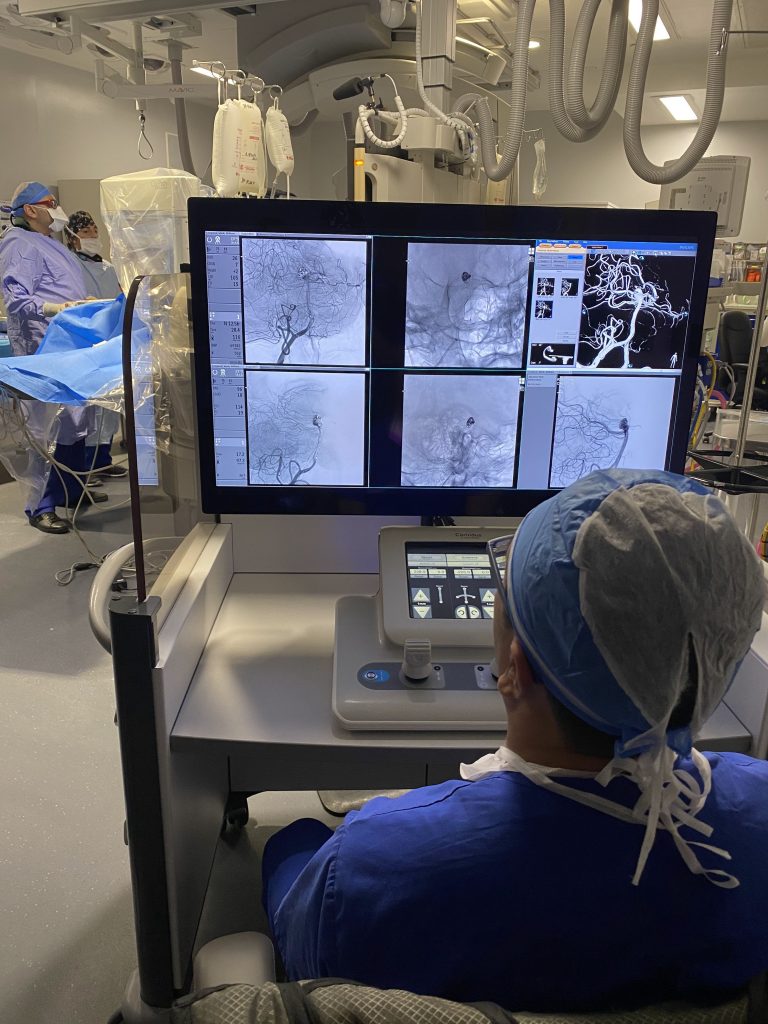 Dr. Vitor Mendes Pereira views images from remote control stent placement for a brain aneurysm.

copyright Roger Boyle